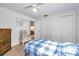 The bedroom has neutral carpet, a ceiling fan and a closet at 3118 Lloyd Dr, Holiday, FL 34691