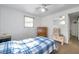 This bedroom features warm carpet, a ceiling fan, a mirror and a wooden dresser at 3118 Lloyd Dr, Holiday, FL 34691