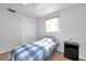 The bedroom features neutral carpet, a ceiling fan, a closet and a large window at 3118 Lloyd Dr, Holiday, FL 34691