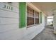 Exterior shot features green shutters and white brick at 3118 Lloyd Dr, Holiday, FL 34691