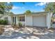 Inviting home with a covered parking area, pretty landscaping and a well-maintained front yard at 3118 Lloyd Dr, Holiday, FL 34691