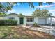 Charming single-story home featuring a well-manicured lawn, green shutters, and an attached garage at 3118 Lloyd Dr, Holiday, FL 34691
