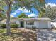 Charming single-story home with a well-manicured lawn and attached garage at 3118 Lloyd Dr, Holiday, FL 34691
