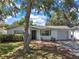 Front exterior of a well-maintained single-Gathering home with an attached garage at 3118 Lloyd Dr, Holiday, FL 34691