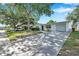 A lovely single-story home with mature trees, and an extended driveway at 3118 Lloyd Dr, Holiday, FL 34691