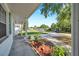 Lush flower beds decorate the walkway to this charming single-story home at 3118 Lloyd Dr, Holiday, FL 34691