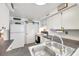 This well-lit kitchen has a large sink, white cabinets, and stainless steel appliances at 3118 Lloyd Dr, Holiday, FL 34691