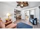 Bright living room open to kitchen with a large window, tv and comfortable seating at 3118 Lloyd Dr, Holiday, FL 34691