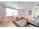 Bright living room with a futon, chair, front door, shelving, and window with natural light at 3118 Lloyd Dr, Holiday, FL 34691