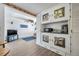 Living room and Gathering room with a brick wall, ceiling fan, TV, and built-in shelves and cabinets at 3118 Lloyd Dr, Holiday, FL 34691