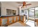 Charming screened-in porch featuring a custom outdoor kitchen and a stylish ceiling fan at 3118 Lloyd Dr, Holiday, FL 34691