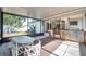 View of screened in porch with dining table and bar area at 3118 Lloyd Dr, Holiday, FL 34691
