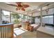 Spacious screened-in porch with a ceiling fan, an outdoor bar, and ample seating for relaxation at 3118 Lloyd Dr, Holiday, FL 34691