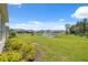 Picture of the expansive, grassy backyard with a pond in the distance at 33466 Landsman Loop, Wesley Chapel, FL 33543