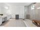 Beautiful bathroom featuring a glass shower with a rainfall showerhead, vanity, and storage cabinet at 33466 Landsman Loop, Wesley Chapel, FL 33543