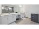 Bright bathroom featuring a vanity with double sinks, a large mirror, and a glass shower at 33466 Landsman Loop, Wesley Chapel, FL 33543
