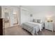 This bedroom features neutral carpet, a double closet, and an ensuite bathroom at 33466 Landsman Loop, Wesley Chapel, FL 33543
