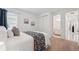 This bedroom features carpet, a double closet, and a view to the ensuite bathroom at 33466 Landsman Loop, Wesley Chapel, FL 33543