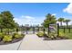 Inviting dog park entrance with secure fencing, signage, and landscaping, providing a safe and enjoyable space for pets at 33466 Landsman Loop, Wesley Chapel, FL 33543