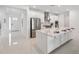 Modern kitchen with white cabinetry, stainless steel appliances, large kitchen island, and gas cooktop at 33466 Landsman Loop, Wesley Chapel, FL 33543