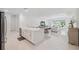 Bright, open-concept kitchen features a farmhouse sink, stainless steel appliances, and a spacious kitchen island at 33466 Landsman Loop, Wesley Chapel, FL 33543