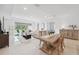 Open living space with sliding glass doors leading to a patio, neutral decor, and plenty of natural light at 33466 Landsman Loop, Wesley Chapel, FL 33543