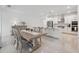 Bright and airy living space with modern kitchen, dining area, and stainless steel appliances at 33466 Landsman Loop, Wesley Chapel, FL 33543