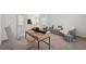 Bright home office space featuring modern desk, comfortable seating, and a view into the living area at 33466 Landsman Loop, Wesley Chapel, FL 33543