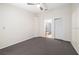 Bedroom features gray carpet, ceiling fan, and access to ensuite bathroom and closet at 4015 Angel Oak Ct # 201, Tampa, FL 33613