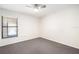 Spacious bedroom with gray carpet, a ceiling fan and a window with blinds at 4015 Angel Oak Ct # 201, Tampa, FL 33613