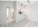 Bright dining area with tile flooring adjacent to an open kitchen area with appliances at 4015 Angel Oak Ct # 201, Tampa, FL 33613