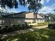 Low angle view of condo building with mature landscaping and an adjacent parking area at 4015 Angel Oak Ct # 201, Tampa, FL 33613