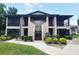 Two-story condo building with screened porches, lush landscaping, and well-maintained grounds at 4015 Angel Oak Ct # 201, Tampa, FL 33613