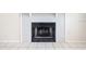 Close-up of a brick fireplace featuring tile flooring and an electric outlet at 4015 Angel Oak Ct # 201, Tampa, FL 33613