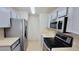Galley kitchen features stainless steel appliances and light-colored cabinets at 4015 Angel Oak Ct # 201, Tampa, FL 33613