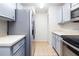 Galley kitchen featuring a stainless steel refrigerator and appliances, and light-colored cabinets at 4015 Angel Oak Ct # 201, Tampa, FL 33613