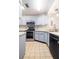 A bright kitchen showcases stainless steel appliances and light-colored cabinets and tiled floor at 4015 Angel Oak Ct # 201, Tampa, FL 33613