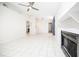 Open-concept living room featuring tile floors, fireplace, and a partial view into the kitchen area at 4015 Angel Oak Ct # 201, Tampa, FL 33613