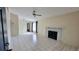 Spacious living room with tile flooring, a ceiling fan, fireplace, and a window for natural light at 4015 Angel Oak Ct # 201, Tampa, FL 33613