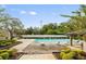 Community pool with lounge chairs and lush landscaping at 4015 Angel Oak Ct # 201, Tampa, FL 33613