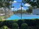 A community tennis court with green hedges surrounding it at 4015 Angel Oak Ct # 201, Tampa, FL 33613