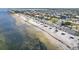 An aerial view shows beach access with parking, seating, and beach pavilions along the shore at 4052 Marine Pkwy, New Port Richey, FL 34652