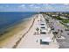 A long stretch of sandy beach with pavilions, parking, and manicured palms, with ocean views at 4052 Marine Pkwy, New Port Richey, FL 34652