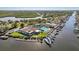 An aerial view shows a waterfront community featuring a community pool, tennis courts, and convenient boat docks at 4052 Marine Pkwy, New Port Richey, FL 34652