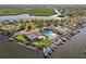An aerial view of a waterfront community with boat docks, tennis courts, and community pool overlooking the water at 4052 Marine Pkwy, New Port Richey, FL 34652