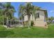 Beautifully landscaped backyard showcasing a large screened-in pool and lush green lawn at 4052 Marine Pkwy, New Port Richey, FL 34652