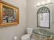 Powder room with unique glass bowl sink and decorative mirror at 4052 Marine Pkwy, New Port Richey, FL 34652