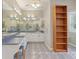 Bright bathroom with dual sinks, large mirror, and built-in shelving for ample storage at 4052 Marine Pkwy, New Port Richey, FL 34652