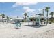 Community beach access with picnic shelters, tables, and lounge chairs at 4052 Marine Pkwy, New Port Richey, FL 34652