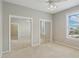 Bedroom with mirrored closet doors and a bright window for natural light at 4052 Marine Pkwy, New Port Richey, FL 34652